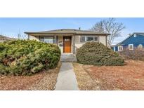 Cute bungalow with a landscaped yard and a welcoming front porch at 1017 Florence St, Aurora, CO 80010