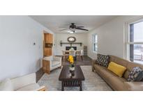 Inviting living room with neutral tones, plush seating, and a dining area nearby at 10645 Routt St, Westminster, CO 80021