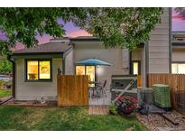 Cozy back patio with table and chairs surrounded by privacy fence and flowers at 8314 S Everett Way # B, Littleton, CO 80128