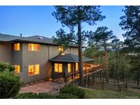 Stunning home featuring a large deck, nestled among mature trees, offering breathtaking views at 28890 Pinewood Vista Dr, Evergreen, CO 80439