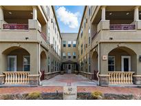 Beautiful condo exterior featuring a courtyard with attractive architectural details and a welcoming entrance at 40 Madison St # 203, Denver, CO 80206