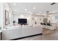 Bright and spacious living room featuring modern decor and an open layout to the kitchen area at 1284 Quitman St, Denver, CO 80204