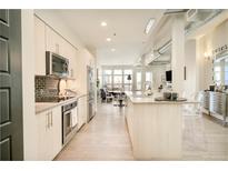 Modern kitchen featuring stainless steel appliances, granite countertops, and an open layout at 3198 Blake St # 502, Denver, CO 80205