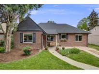 Charming brick home featuring a manicured lawn, mature trees, and inviting curb appeal at 1380 Magnolia St, Denver, CO 80220