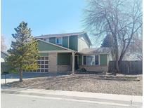 Charming two-story home with a well-manicured lawn and attached garage at 9852 W 76Th Ave, Arvada, CO 80005