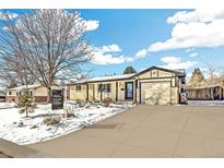 Charming single-story home with a well-maintained yard and a convenient attached garage, perfect for suburban living at 8509 Ames St, Arvada, CO 80003