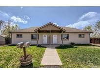Charming duplex featuring a shared porch, well-maintained lawn, and a convenient walkway at 1121 Rogers St, Golden, CO 80401