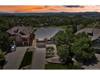 Stunning aerial view of a home with a beautiful landscape and mountain views in a desirable neighborhood at 1975 Wild Star Way, Castle Rock, CO 80104