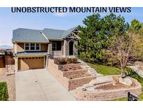 Charming two-story home with a stone facade, tiered front yard landscaping, and a two-car garage at 1975 Wild Star Way, Castle Rock, CO 80104