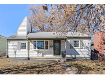 Charming single-Gathering home featuring a well-maintained front yard and traditional architectural details at 1325 Dayton St, Aurora, CO 80010