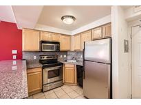 Cozy kitchen featuring stainless steel appliances and light wood cabinets at 1833 N Williams St # 402, Denver, CO 80218