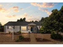 Charming single-story home with manicured front yard and inviting entrance walkway at 707 Uvalda St, Aurora, CO 80011