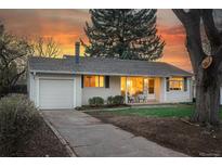 Charming home featuring a well-maintained lawn, a cozy front porch, and an attached one car garage at 2975 S Jackson St, Denver, CO 80210