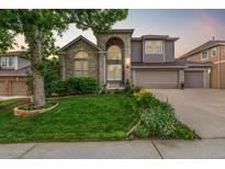 Beautiful two-story home with landscaped front yard, arched entryway and a three car garage at 9552 E Caley Cir, Englewood, CO 80111