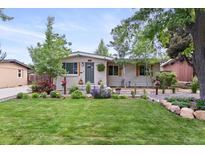 Charming single-story home with a lush, well-manicured front yard and mature trees at 250 W Midway Blvd, Broomfield, CO 80020