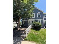 Charming two-story home with blue siding, green lawn, and steps leading up to the front door at 2280 S Jasper Way # A, Aurora, CO 80013
