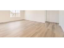 Bright bedroom with light wood flooring and large windows offering ample natural light at 22015 E 39Th Ave, Aurora, CO 80019