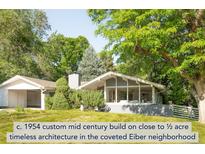 Charming mid-century home with lush landscaping and mature trees, offering a serene and private setting at 950 Everett St, Lakewood, CO 80215