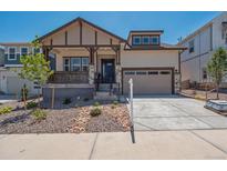 Charming craftsman-style home with a covered porch and well-maintained landscaping in a suburban neighborhood at 8250 Snake River St, Littleton, CO 80125