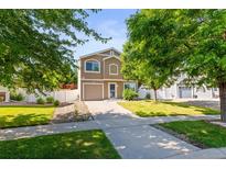 Well-maintained two-story home with a manicured lawn, driveway, and charming curb appeal at 18672 E Chaffee Pl, Denver, CO 80249