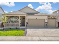 Charming single-Gathering home with a stone-accented facade and a spacious three-car garage at 4723 Windmill Dr, Brighton, CO 80601