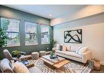 Inviting living room featuring large windows, modern decor, neutral color palette, and comfortable seating at 1919 W 46Th Ave # 3, Denver, CO 80211