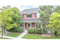 Charming two-story home with a covered porch and well-manicured lawn at 8367 Devinney St, Arvada, CO 80005