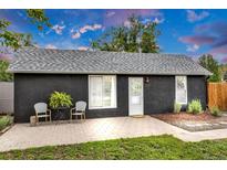 Charming home featuring a dark exterior, well-kept lawn, and a cozy patio area at 211 E Emma St, Lafayette, CO 80026