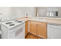 Well-lit kitchen featuring an electric range, white cabinets, and sleek countertops at 336 N Grant St # 302, Denver, CO 80203