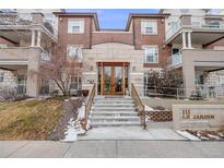 Beautiful building exterior with stone and brick and landscaped entrance at 111 S Monroe St # B203, Denver, CO 80209