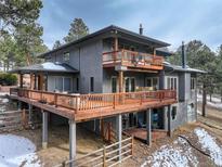 Stunning two-story home with large deck and mountain views at 28890 Pinewood Vista Dr, Evergreen, CO 80439