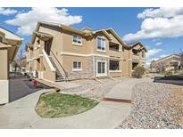 Inviting condo exterior with stone accents, landscaped grounds, and well-maintained walkway at 4730 Copeland Cir # 203, Highlands Ranch, CO 80126