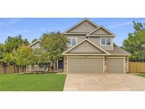 Charming two-story home featuring a three-car garage, well-maintained lawn and beautiful, mature trees at 5206 S Meadow Lark Dr, Castle Rock, CO 80109