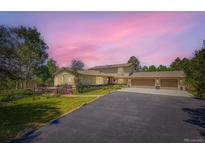 Spacious home with a three-car garage and well-maintained landscaping at 18680 Knollwood Blvd, Monument, CO 80132
