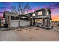 Beautiful two-story home with a spacious three-car garage and covered front porch, perfect for enjoying the scenic neighborhood at 7786 Windwood Way, Parker, CO 80134