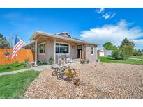 Charming home featuring a quaint porch and delightful decorative bicycle accents in the front yard at 1775 Longbranch St, Strasburg, CO 80136