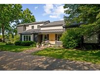 Inviting home exterior with a brick pathway and landscaped yard leading to the front door at 1 Sedgwick Dr, Cherry Hills Village, CO 80113