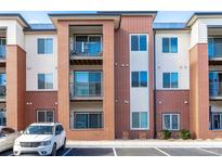 Attractive brick building exterior with balconies and ample parking at 14351 E Tennessee Ave # 305, Aurora, CO 80012