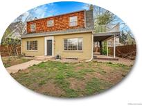 Charming two-story home with a unique wood-shingled upper level and inviting covered patio at 240 Colorado Blvd, Denver, CO 80206