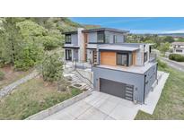 Stunning contemporary home featuring a three-car garage and modern design elements at 202 October Pl, Castle Rock, CO 80104