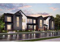 Modern three-unit townhome development with two-car garages at 6942 Huddersfield Ln, Castle Pines, CO 80108