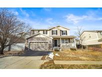 Two-story house with a front porch and attached garage at 677 N 48Th Ave, Brighton, CO 80601