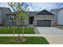 Charming single-Gathering home featuring a well-manicured lawn, stone accents, and an attached two-car garage at 2536 Lupton Ln, Lafayette, CO 80026