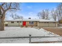 Charming home featuring a bright red front door and a spacious two-car garage at 7250 W Vassar Ave, Lakewood, CO 80227