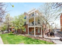 Attractive brick building with multiple balconies and well-maintained landscaping at 1560 Milwaukee St # 240, Denver, CO 80206