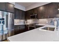 Modern kitchen featuring stainless steel appliances, sleek countertops, and stylish cabinetry at 20 Wilcox St # 621, Castle Rock, CO 80104