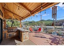 Enjoy mountain views from this deck with outdoor kitchen, perfect for entertaining and relaxation at 829 Colorado Blvd, Idaho Springs, CO 80452