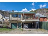 Two-story home featuring multi-car garage, and a second story deck at 829 Colorado Blvd, Idaho Springs, CO 80452