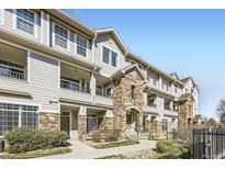 Inviting condo exterior with stone accents, covered balconies and manicured landscaping offers charm and curb appeal at 12711 Colorado Blvd # 305C, Thornton, CO 80241