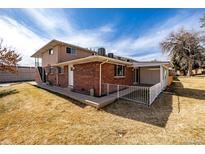 Spacious backyard featuring a brick house with a covered patio and a well-maintained lawn at 3611 W 79Th Ave # B4, Westminster, CO 80030